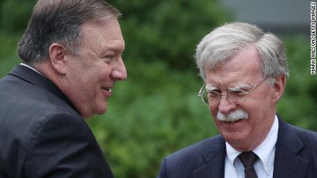 Mike Pompeo talks with  John Bolton before a in  Rose Garden news conference in June 2018.