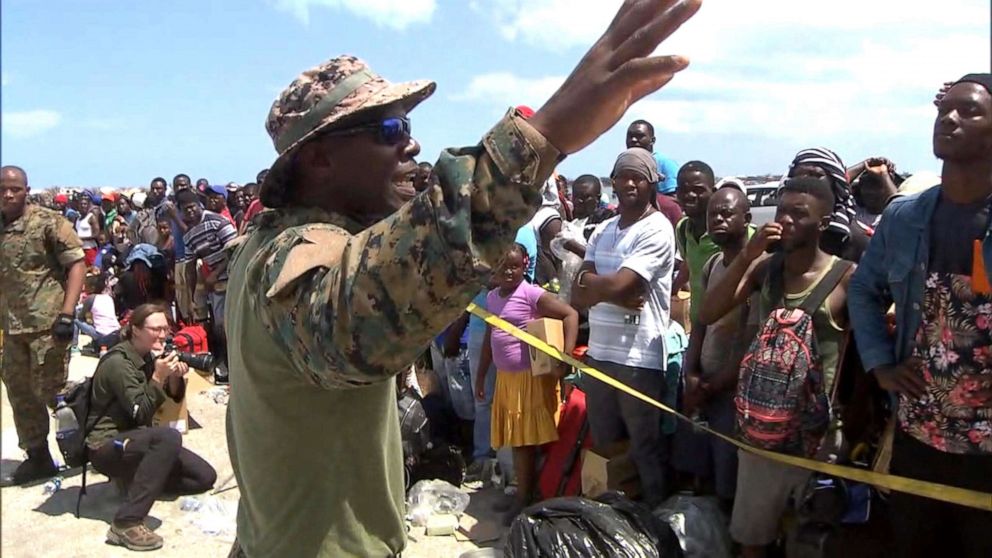 PHOTO: Senior Lt. William Sturrup of the Royal Bahamian Defense Force tells desperate evacuees to be patient as they wait to leave the Abaco Islands after they were hit by Hurricane Dorian. 