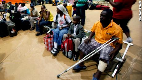 A group of evacuees from Haiti wait for transportation as they clear customs at Homestead Air Reserve Base, Florida, in January 2010.