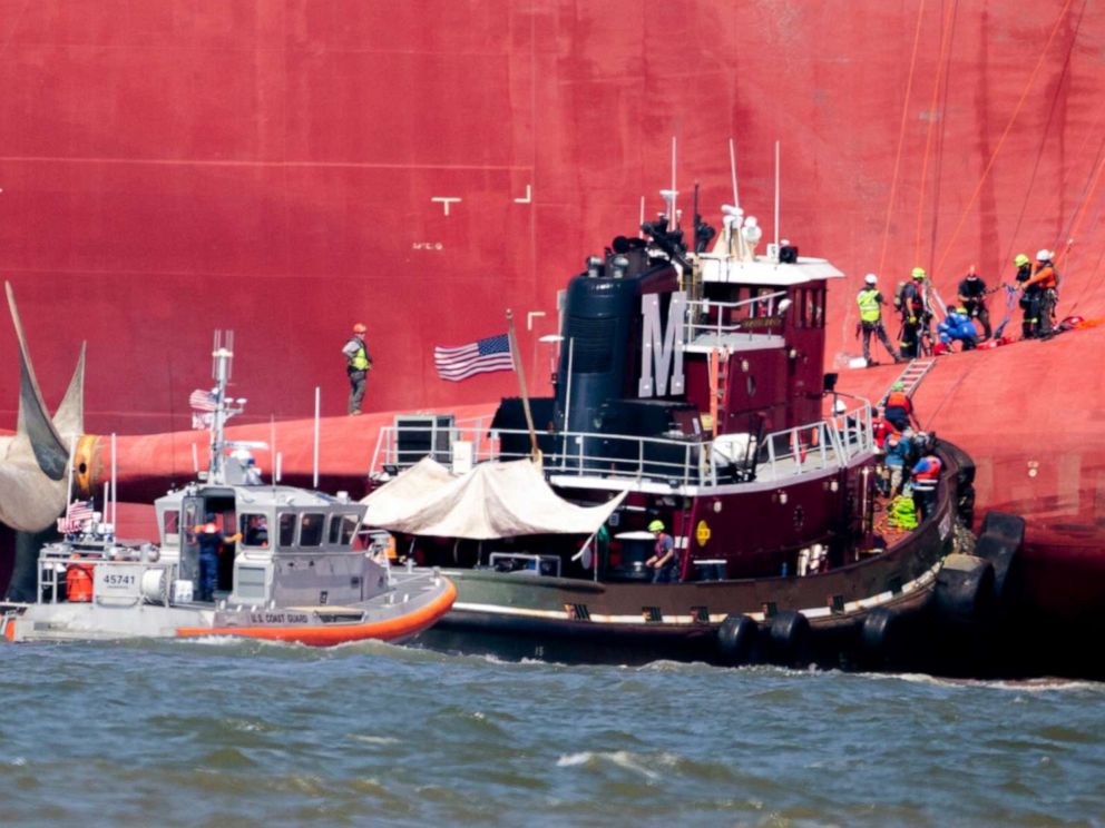 PHOTO: Rescuers work near the stern of the vessel Golden Ray as it lays on its side near the Moran tug boat Dorothy Moran, Monday, Sept. 9, 2019, in Jekyll Island, Ga.