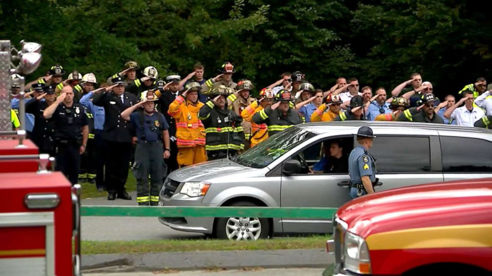 PHOTO: Firefighters salute outside of the Medical Examiners Office after a firefighter was killed in an explosion in Farmington, Maine, Sept. 16, 2019.