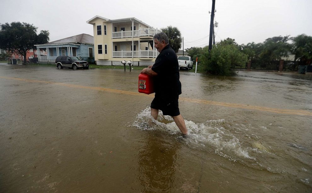 PHOTO: Angel Marshman carries a gas can as he walks through floodwaters from Tropical Depression Imelda to get to his flooded car, Sept. 18, 2019, in Galveston, Texas.