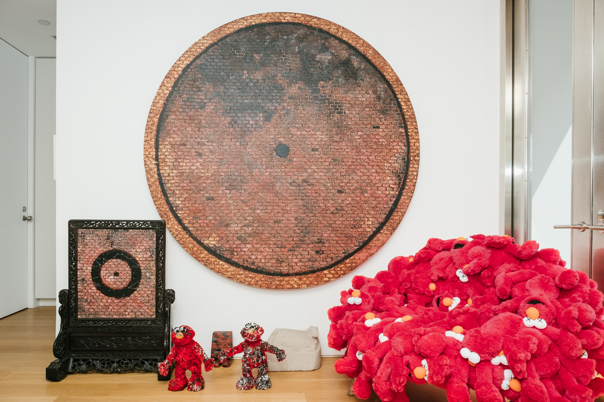 Works in Donnelly’s studio by Martin Wong, Joyce Pensato, and William Edmonson near KAWS Chair Red (Elmo Plush) by Fernando and Humberto Campana.PHOTO: DONALD STAHL FOR ARTNEWS