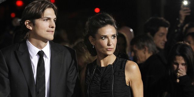 Cast member Ashton Kutcher and his wife actress Demi Moore attend the premiere of "No Strings Attached" at the Regency Village theatre in Los Angeles January 11, 2011. The movie opens in the U.S. on January 21. REUTERS/Mario Anzuoni (UNITED STATES - Tags: ENTERTAINMENT) - RTXWGKZ