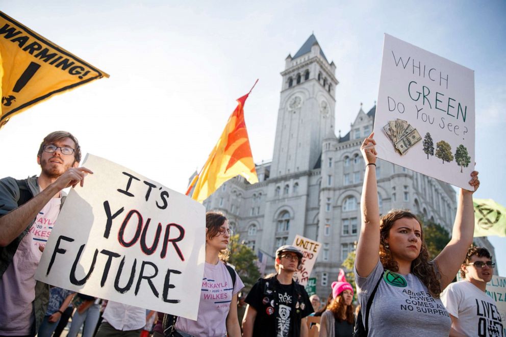 PHOTO: Climate change activists with Shut Down DC block rush hour traffic as they walk by the Trump International Hotel during a protest march in Washington, DC, Sept. 27, 2019.