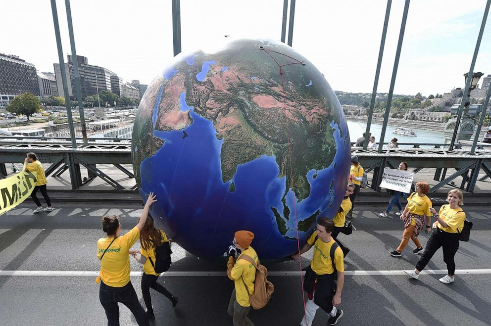 PHOTO: Protesters march with a globe balloon on the oldest Hungarian bridge, the Lanchid (Chain Bridge) during the Global Climate Strike organized by the Fridays For Future Hungary at the end of the global climate change week in Budapest.