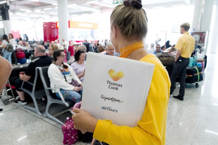 Thomas Cook staff giving information to British passengers at Palma de Mallorca airport on Monday.&nbsp;