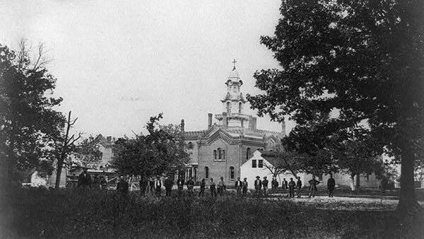 A Civil War-era image of Virginia Theological Seminary shows Union soldiers and black civilians standing in front of the semi