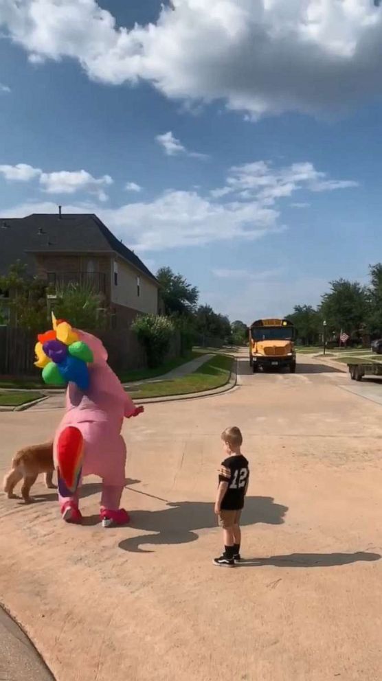 PHOTO: Dad Chris Scandridge of Texas, filmed last week as his wife Somer Scandridge danced up the block in her giant, pink costume to greet 6-year-old Madison.