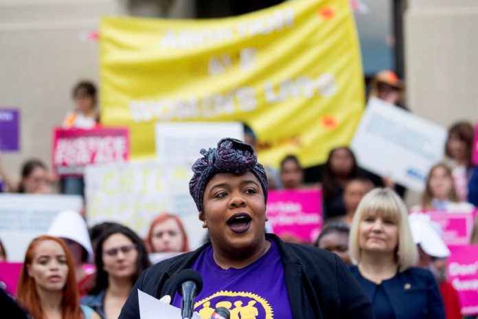 Michelle Wilson, Program Manager for Women Engaged, speaks out against Georgia's restrictive abortion bill and for reproductive justice at a press conference outside of the Georgia State Capitol following the signing of HB 481 in Atlanta, Tuesday, May 7, 2019. Georgia Governor Brian Kemp signed the bill, surrounded by supporters and Georgia lawmakers, in his office Tuesday morning. (ALYSSA POINTER/ALYSSA.POINTER@AJC.COM)