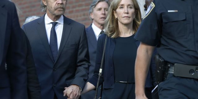 Felicity Huffman leaves federal court with her husband William H. Macy, left, and her brother Moore Huffman Jr. rear center, after she was sentenced in a nationwide college admissions bribery scandal, Friday, Sept. 13, 2019, in Boston.