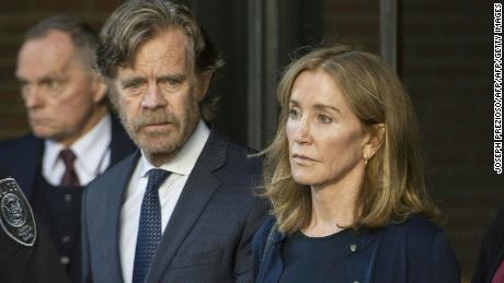 Actress Felicity Huffman, escorted by her husband William H. Macy, exits the US courthouse in Boston, after her sentencing on September 13, 2019.