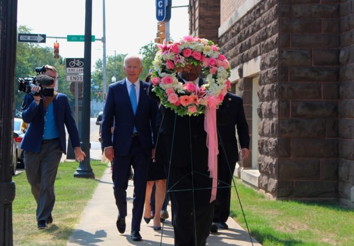 Former Vice President and presidential candidate Joe Biden, center left, joins Sen. Doug Jones and Birmingham Mayor Randall Woodfin at a wreath laying after a service at 16th Street Baptist Church in Birmingham, Ala., Sunday, Sept. 15, 2019. Visiting the black church bombed by the Ku Klux Klan in the civil rights era, Democratic presidential candidate Biden said Sunday the country hasn't 