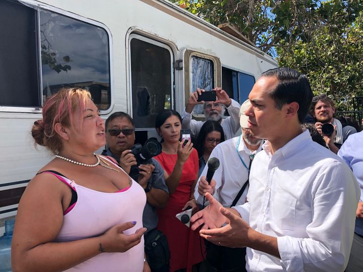 Juli&aacute;n Castro speaks with Maria Fuentes, a homeless resident at an encampment in Oakland.