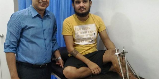 Karan Sharma (right) is seen after surgery to reattach his severed foot.