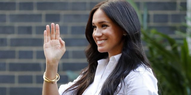 Meghan, the Duchess of Sussex, waves as she leaves a department store after launching the Smart Works capsule collection in London. 