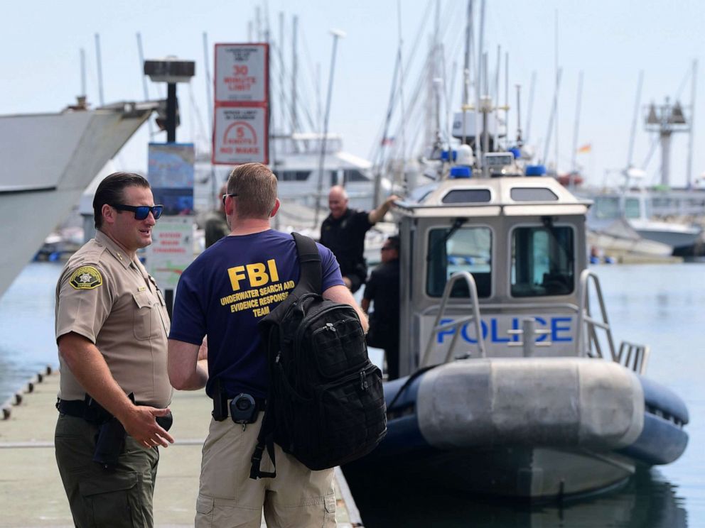 PHOTO: An officer from the FBI underwater search and evidence response team speaks with a California law enforcement officer near a Long Beach Police vessel in Santa Barbara, Calif., Sept. 3, 2019.