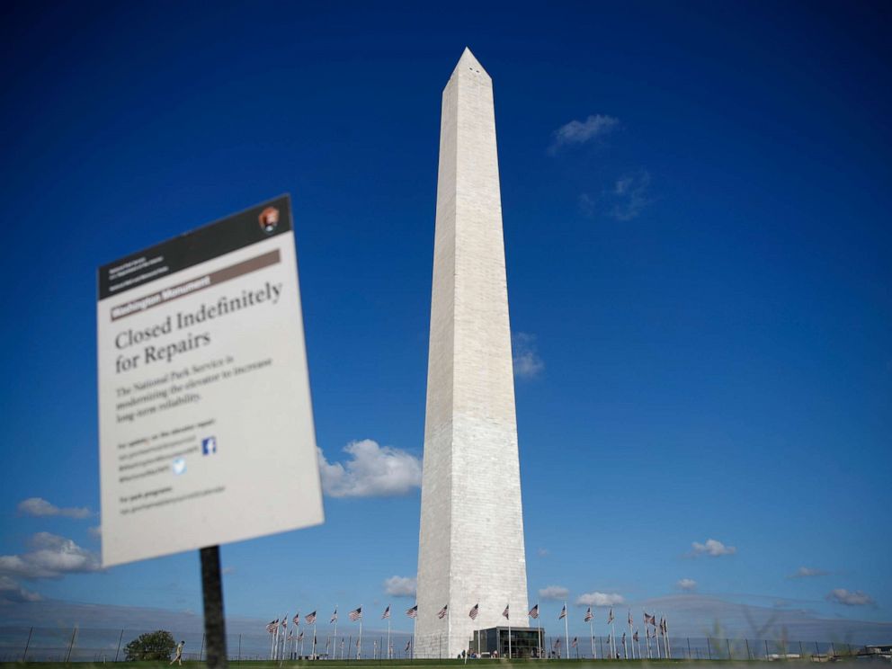 PHOTO: The Washington Monument is seen past a sign greeting visitors during a press preview tour ahead of the monuments official reopening, Wednesday, Sept. 18, 2019, in Washington.