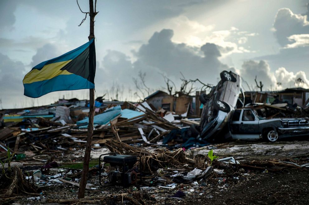 PHOTO: A Bahamas flag flies amidst the rubble left by Hurricane Dorian in Abaco, Bahamas, Sept. 16, 2019. Dorian hit the northern Bahamas on Sept. 1, with sustained winds of 185 mph, unleashing flooding that reached 25 feet in some areas.