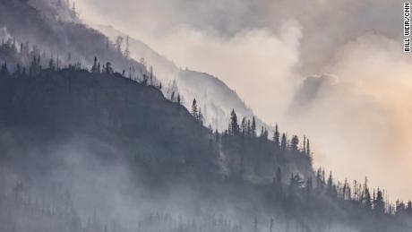 Smoke from the Swan Lake fire blankets a hillside.