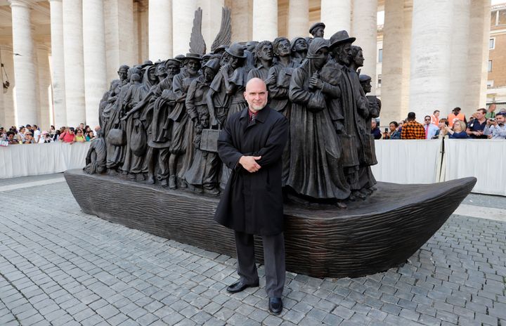 Sculptor Timothy P. Schmalz with his statue Sunday at the Vatican.
