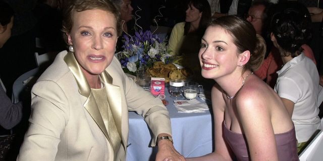 Julie Andrews, left, clutches Anne Hathaway's hand at an after following the premiere of "The Princess Diaries" at El Capitan Theatre on July 29, 2001, in Hollywood, Calif.