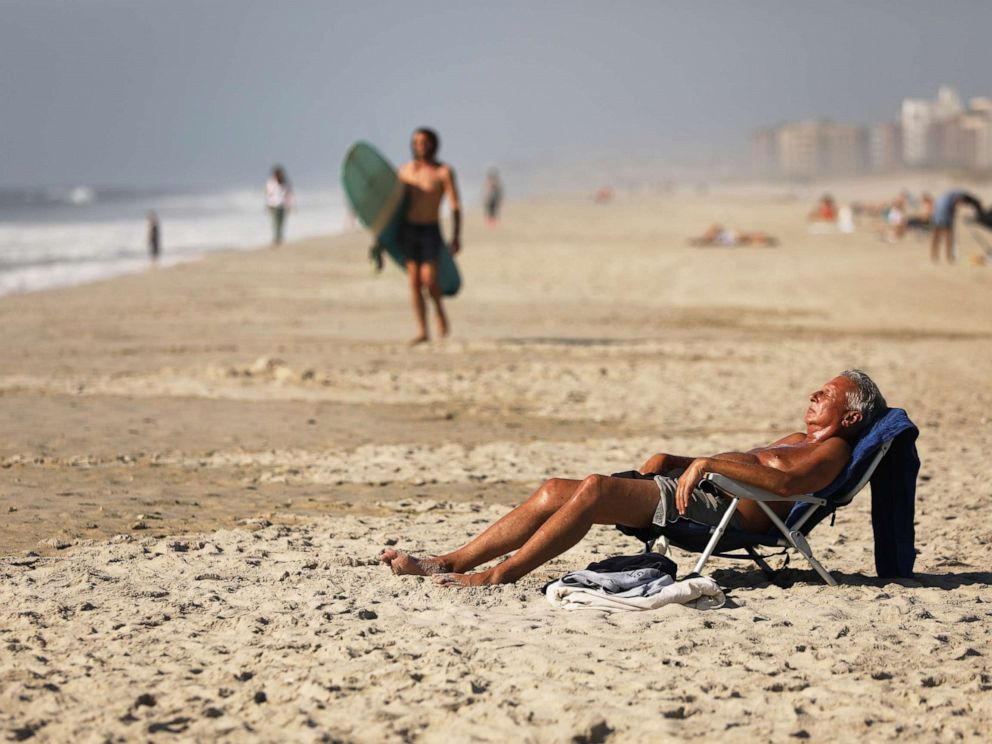 PHOTO: People enjoy the unseasonably warm weather as park rangers continue to search for two missing swimmers at Rockaway Beach on October 02, 2019, in New York.