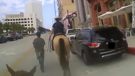 The body camera footage shows the officers leading Neely through the streets of Galveston.