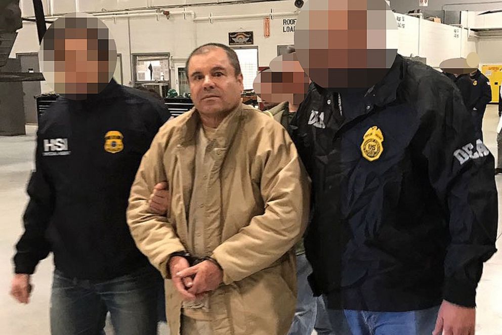 PHOTO: Joaquin Guzman Loera aka El Chapo Guzman (C) is escorted in Ciudad Juarez by the Mexican police as he is extradited to the United States.