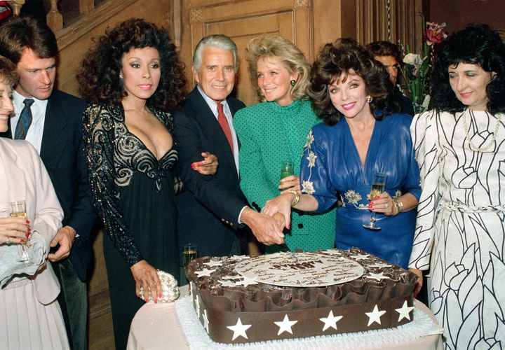 Cast members of "Dynasty" cut a cake to commemorate the production of 150 episodes of the television series in Los Angeles, C