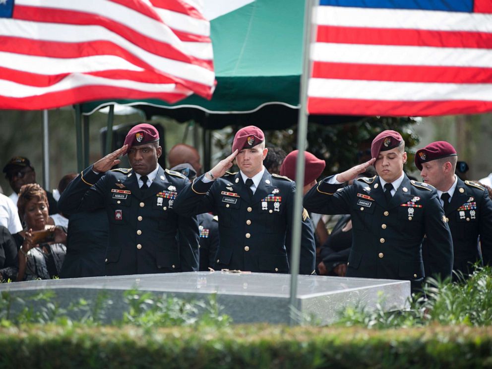 PHOTO: Members of the 3rd Special Forces Group, 2nd battalion salute the casket of Army Sgt. La David Johnson at his burial service in the Memorial Gardens East cemetery, Oct. 21, 2017 in Hollywood, Fla.