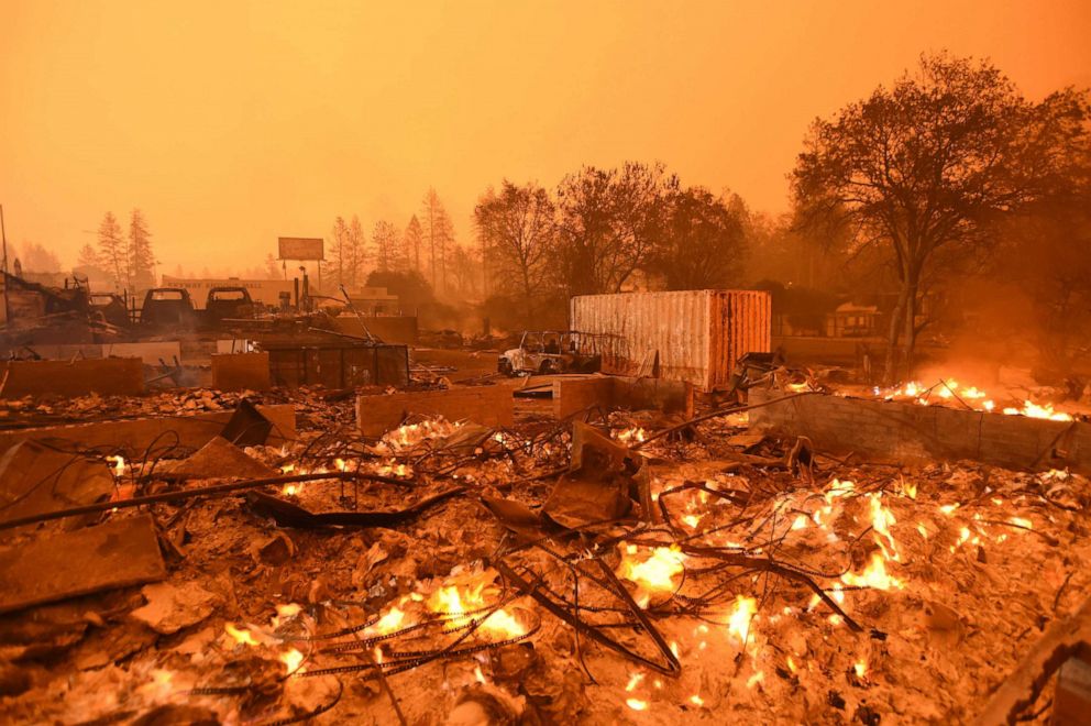 PHOTO: Businesses continue to burn under a darkened smokey sky in Paradise, north of Sacramento, Calif., Nov. 09, 2018.