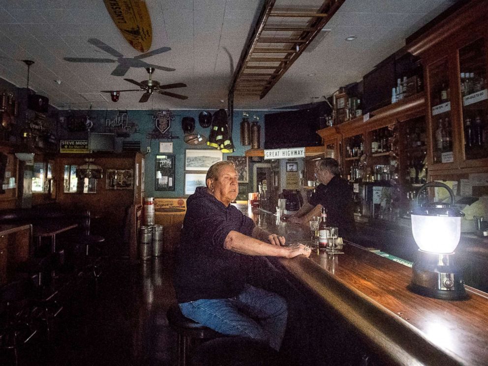 PHOTO: Joseph Pokorski drinks a beer at The Town Square as downtown Sonoma, Calif., remains without power, Oct. 9, 2019.