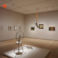 In the foreground are Marcel Duchamp’s iconic, groundbreaking readymades of a bicycle wheel and a shovel.