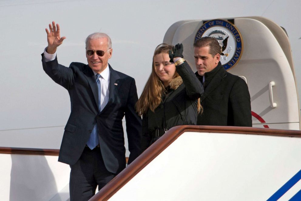 PHOTO: Vice President Joe Biden waves as he walks out of Air Force Two with his granddaughter Finnegan Biden and son Hunter Biden at the Beijing airport on Dec. 4, 2013.