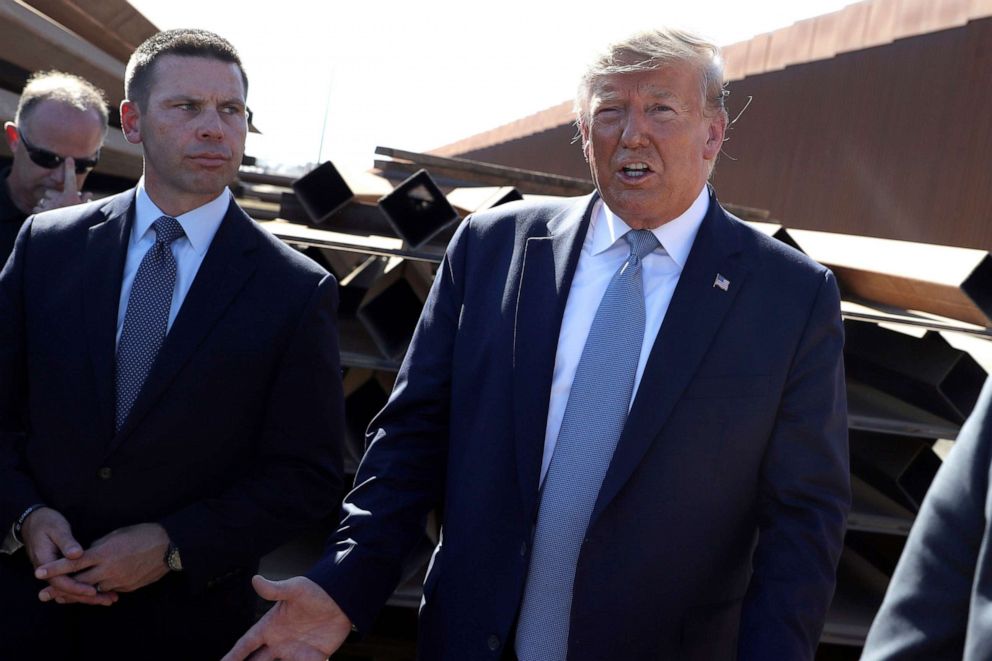 PHOTO: President Donald Trump talks with reporters as he tours a section of the southern border wall, in Otay Mesa, Calif., as acting Homeland Secretary Kevin McAleenan listens, Sept. 18, 2019.