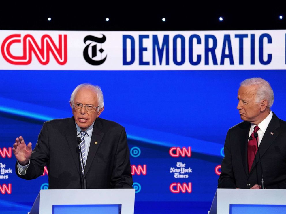 PHOTO: Former Vice President Joe Biden looks on as Senator Bernie Sanders speaks during the fourth Democratic presidential debate at Otterbein University in Westerville, Ohio, Oct. 15, 2019.