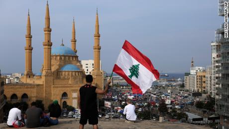 An anti-government protester holds up a Lebanese national flag in Beirut on Friday.