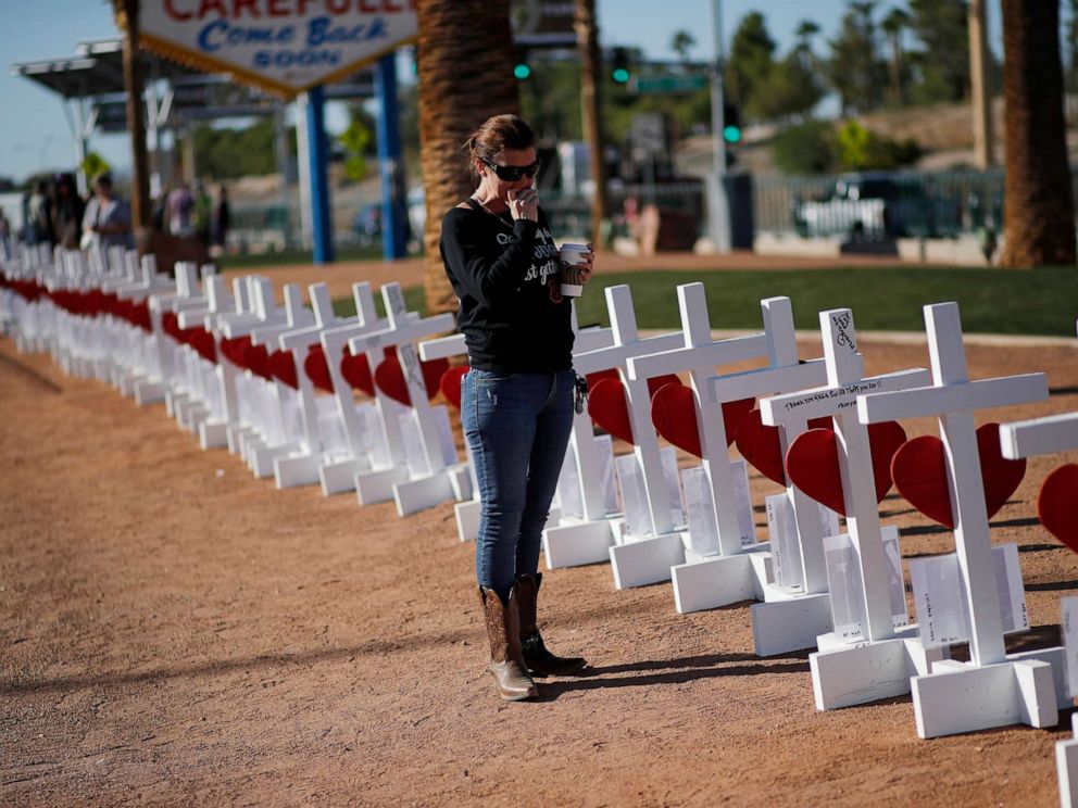 PHOTO: Jill Hale stands at a makeshift memorial for shooting victims, Tuesday, Oct. 1, 2019, in Las Vegas, on the anniversary of the mass shooting two years earlier. 