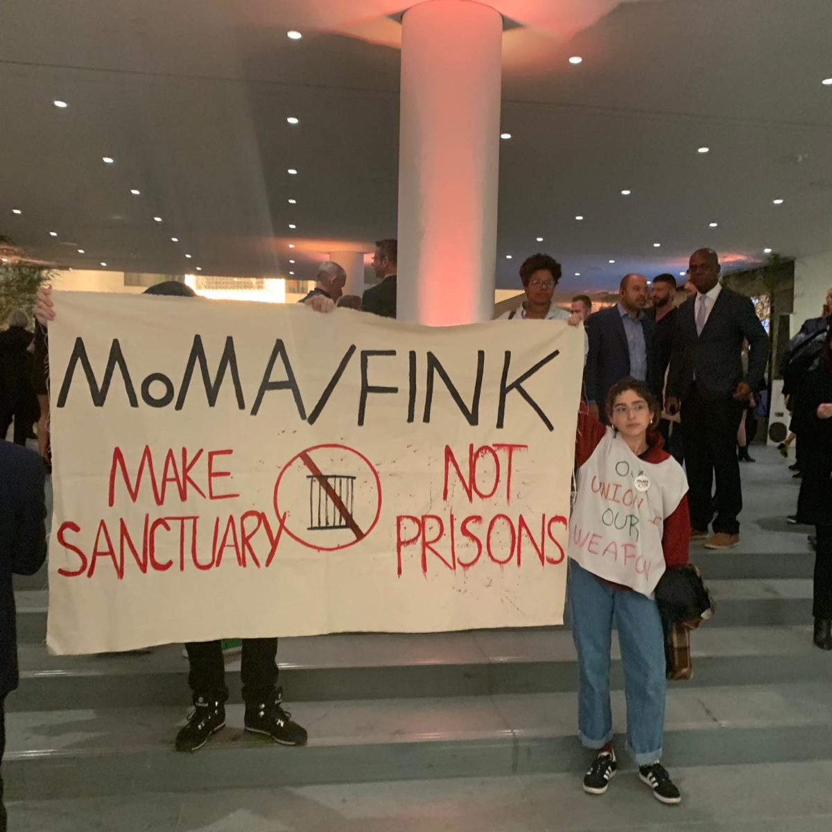 A protest at the Museum of Modern Art's opening party on October 18, 2019.