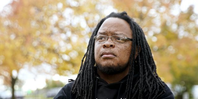 Marlon Anderson poses for a photo Thursday, Oct. 17, 2019 in Madison, Wis. Anderson, a security guard at a Wisconsin high school, was fired after he says he repeated a racial slur while telling a student who had called him that word not to use it. He has filed a grievance seeking his job back.