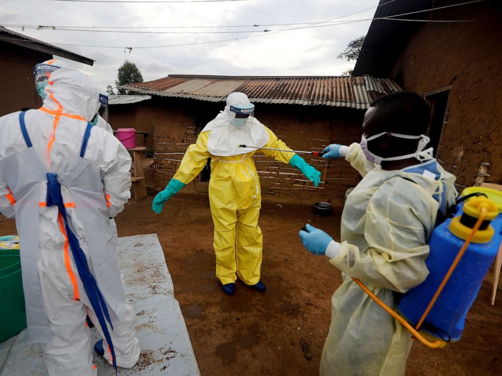 PHOTO: Kavota Mugisha Robert, a healthcare worker, vdecontaminates his colleague after he entered the house of 85-year-old woman, suspected of dying of Ebola, in the eastern Congolese town of Beni in the Democratic Republic of Congo, Oct. 8, 2019.