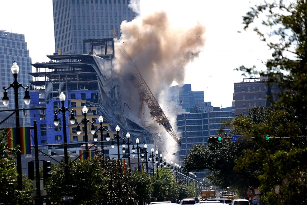 PHOTO: Two large cranes from the Hard Rock Hotel construction collapse come crashing down after being detonated for implosion in New Orleans, Oct. 20, 2019.
