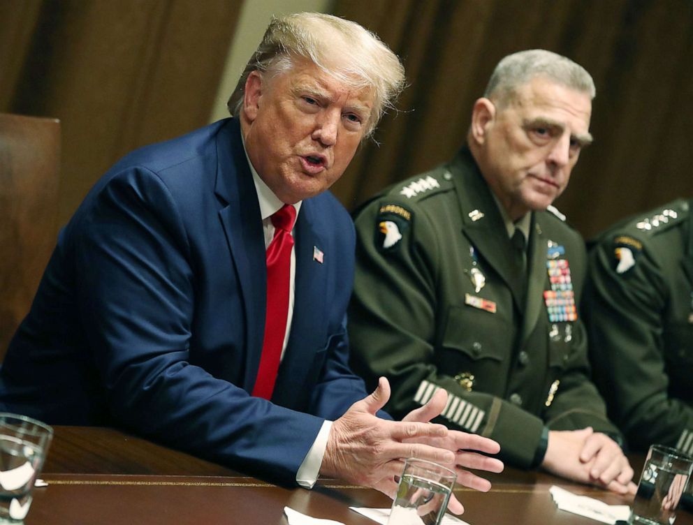 PHOTO: President Donald Trump speaks as Joint Chiefs of Staff Chairman, Army General Mark Milley looks on after a briefing from senior military leaders in the Cabinet Room at the White House on Oct. 7, 2019 in Washington, D.C.