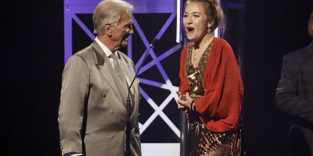 Lauren Daigle, right, accepts the song of the year award from Pat Boone, left, during the Dove Awards on Tuesday, Oct. 15, 2019, in Nashville, Tenn.