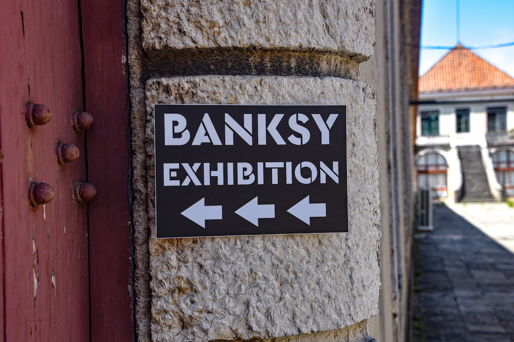 A sign for the Banksy exhibition "Genius or Vandal" at the Cordoaria Nacional in Lisbon, Portugal, earlier this year.