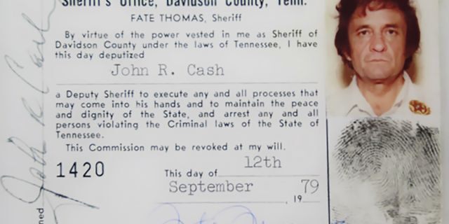 This 1979 image released by the Davidson County (Tenn.) Sheriff's Office via the Johnny Cash Museum, shows Cash's Deputy Sheriff ID card. This week at the Johnny Cash Museum in Nashville, Tenn., Nashville Sheriff Daron Hall unveiled a blown-up image of the late musician's September 1979 deputy sheriff commission card. The card authorized Cash to "execute any and all processes that may come into his hands and to maintain the peace and dignity of the State, and arrest any and all persons violating the Criminal laws of the State of Tennessee."