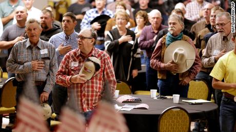 The Pledge of Allegiance is recited in Omaha, Nebraska, at the start of a meeting to urge President Trump to ensure fair prices for cattle farmers and ranchers.