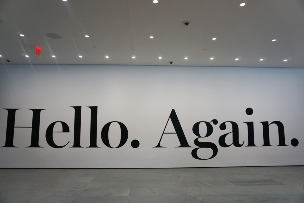 Haim Steinbach’s 2013 vinyl work 'hello again' is mounted to the wall on MoMA’s first floor, welcoming visitors to the newly expanded museum. The work was acquired specifically for the reopening.