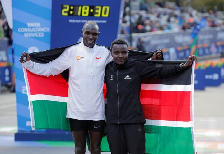 Kenya's Geoffrey Kamworor and Kenya's Joyciline Jepkosgei pose as they celebrate winning the men's and women's elite races re